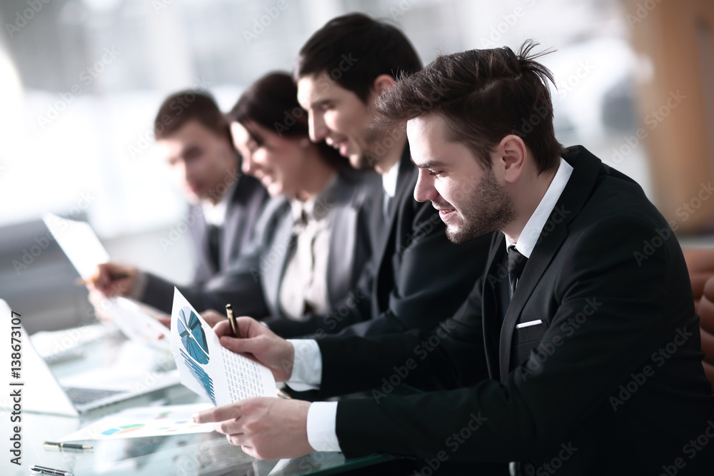 Smiling business people with paper work in board room Smiling business people with paper work in board room