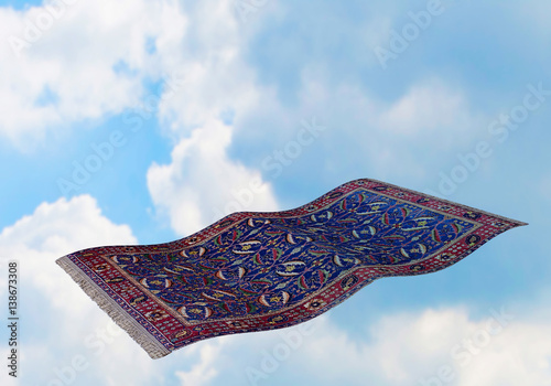 Surrealistic flying carpet against blue sky and white clouds. 3D rendering