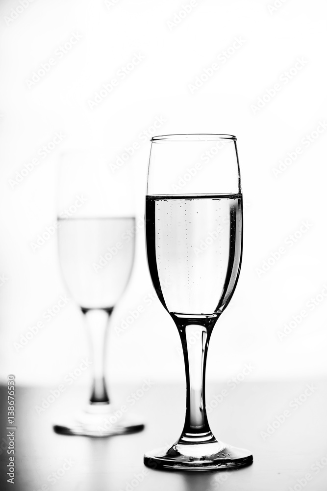 monochrome photo of champagne on white table on white background isolate monochrome photo of champagne on white table on white background isolate
