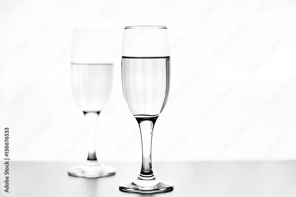 monochrome photo of champagne on white table on white background isolate monochrome photo of champagne on white table on white background isolate