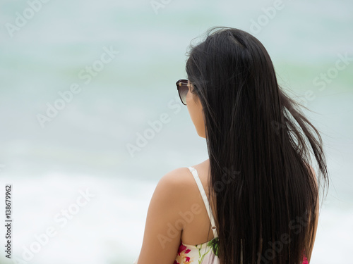 Young beautiful woman looking at the sea waves