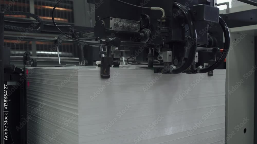 Offset printing press, industrial machine moving the paper material. Print house. Close-up. 4k footage.
Offset printing press, industrial machine moving the paper material. Print house. Close-up. 4k footage.