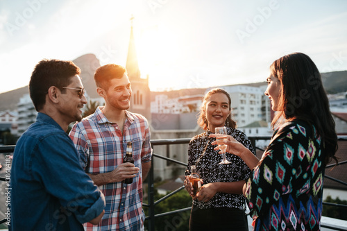 Photography Young men and women having a rooftop party