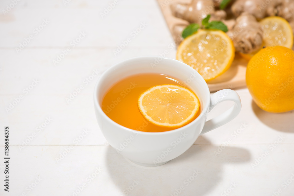 Cup of Ginger Tea with Lemon and Honey on a White Wooden Background. Cup of Ginger Tea with Lemon and Honey on a White Wooden Background.