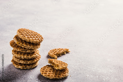 Glass cups of coffee with mini stroopwafel, syrupwaffles cookies on light gray background with copy space. Retro style toned. photo