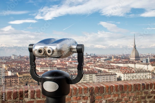 Turin, Italy - February 20, 2017: Touristic telescope look at the city Turin (Torino), close up metal binoculars on background viewpoint overlooking the mountain