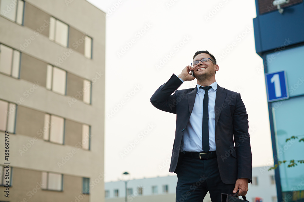 Modern businessman speaking by smartphone outdoors Modern businessman speaking by smartphone outdoors