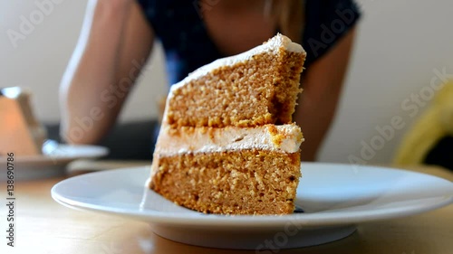 Young girl eating pumpkin cake in the cafe.