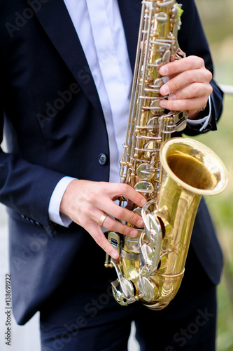 handsome musician is playing saxophone photo