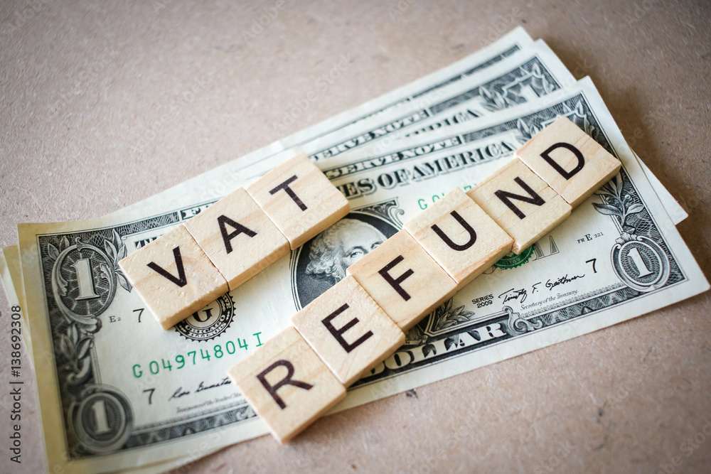 Wooden block word VAT REFUND and Dollar banknote