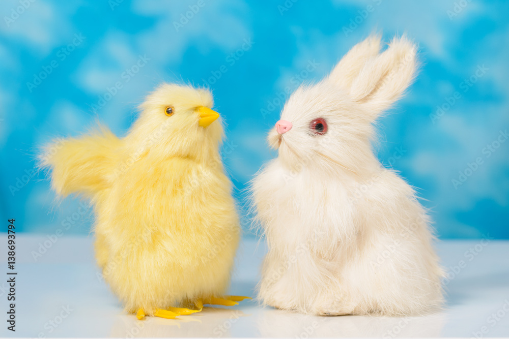 Bunny and chick on a blue sky background .