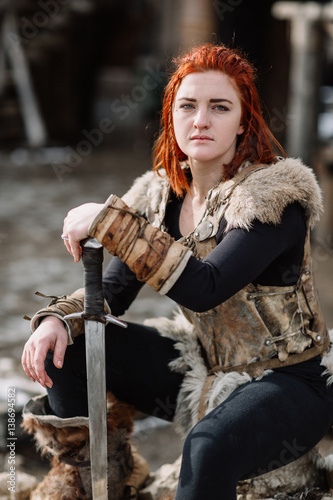 portrait of a girl in a Viking outfit, red hair. photo