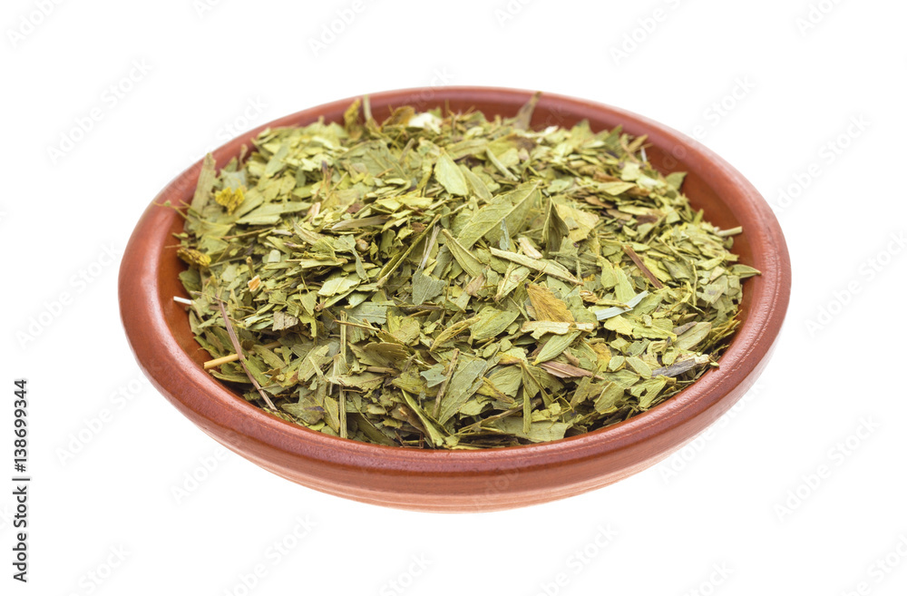 Bowl filled with cut and sifted senna leaf isolated on a white background. Bowl filled with cut and sifted senna leaf isolated on a white background.