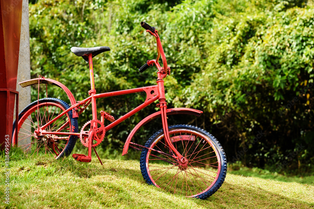 Retro red bike parking on field