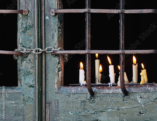 Yahrzeit candles near the closed door of the chapel of the Bom Jesus do Monte - Braga, Portugal photo