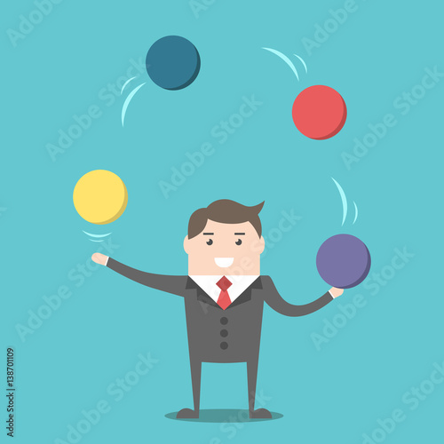 Businessman juggling spheres
