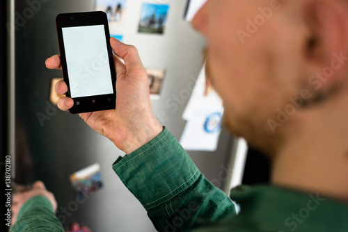 Fototapeta Naklejka Na Ścianę i Meble -  Person hands holding smartphone with white screen
