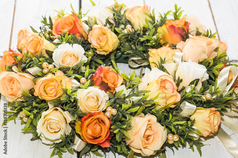 Wedding wreath with roses on white wooden background Wedding wreath with roses on white wooden background