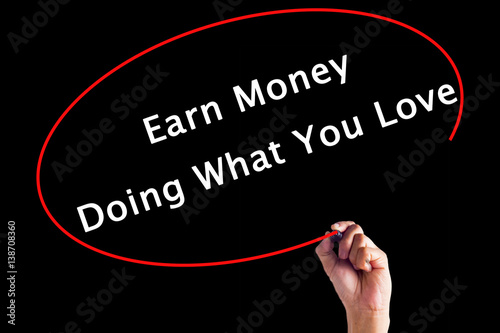 Hand Writing Earn Money Doing What You Love with a marker over transparent board
