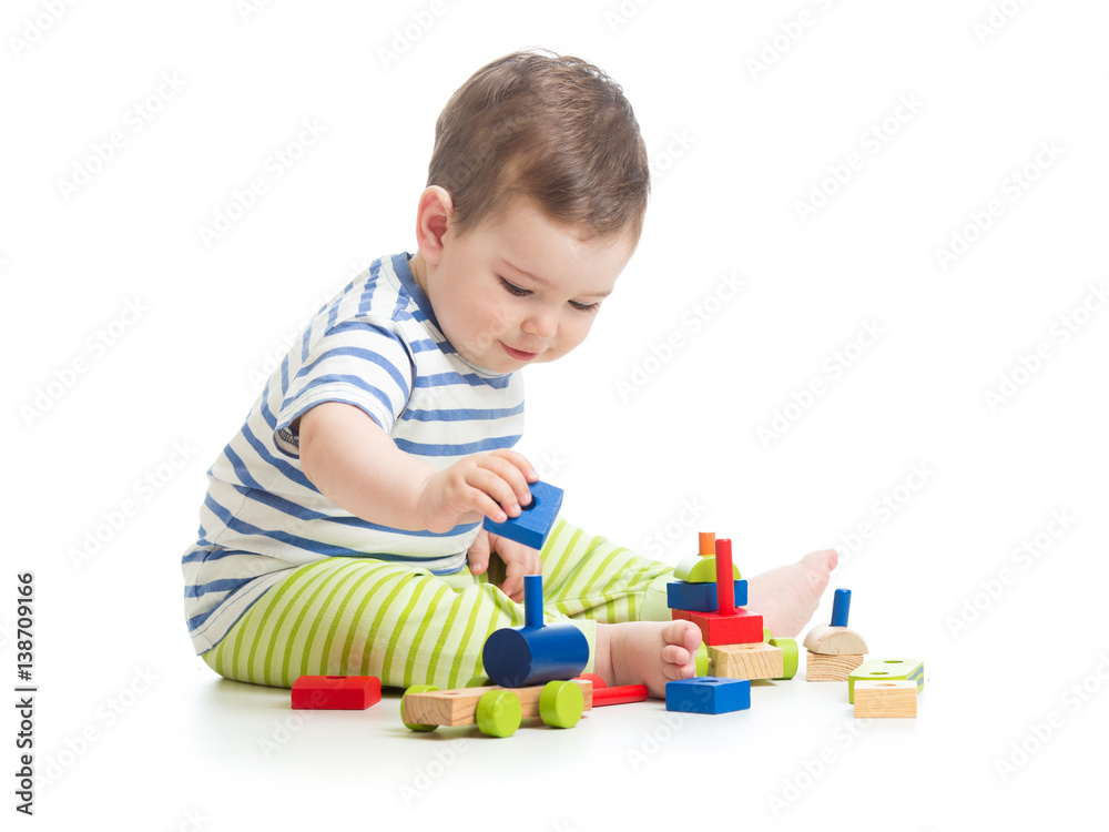Baby boy playing with blocks toys isolated on white Baby boy playing with blocks toys isolated on white