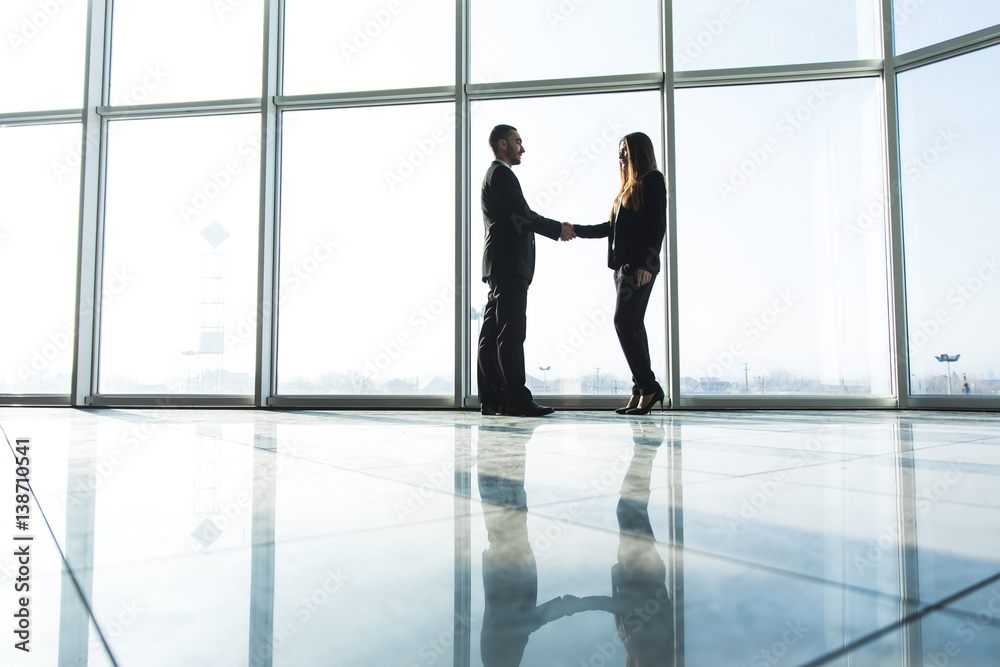 business people shaking hands over office background business people shaking hands over office background