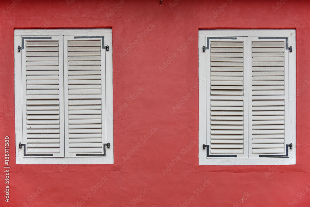 White wooden window on red wall