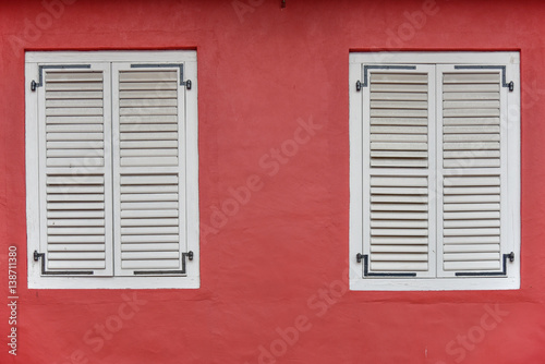 White wooden window on red wall