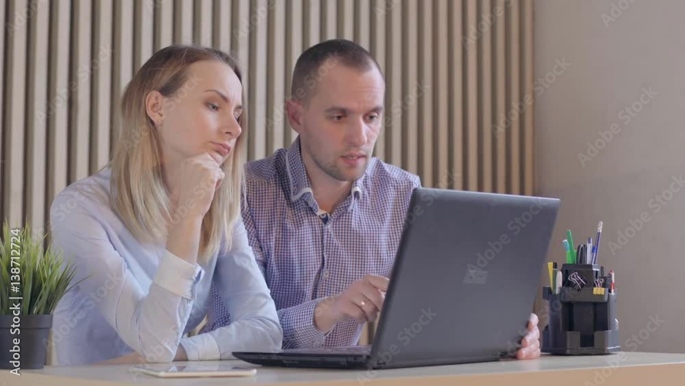 Business partners with papers and a computer Business partners with papers and a computer