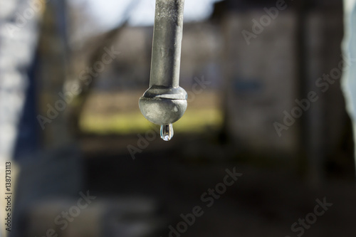 Drop water hanging at the tip of the iron rod
