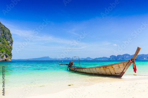 Thailand summer travel sea, Thai old wood boat at sea beach Krabi Phi Phi Island Phuket park on white sand blue sky emerald green ocean water. © Quality Stock Arts