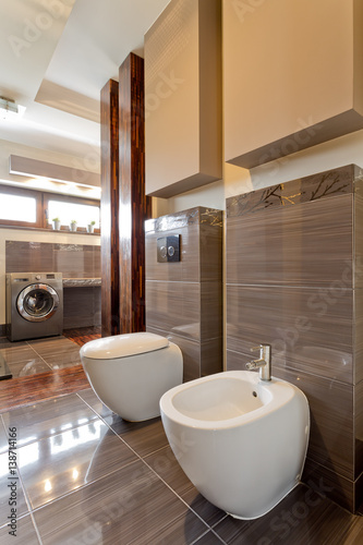 Spacious brown bathroom with toilet