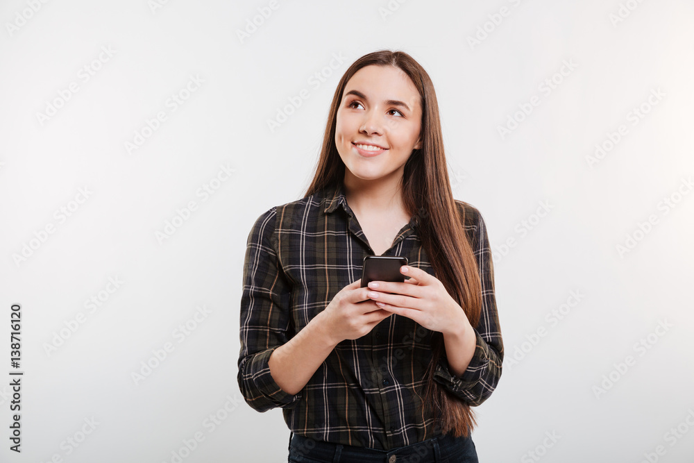 Pensive Smiling Woman in shirt with phone Pensive Smiling Woman in shirt with phone