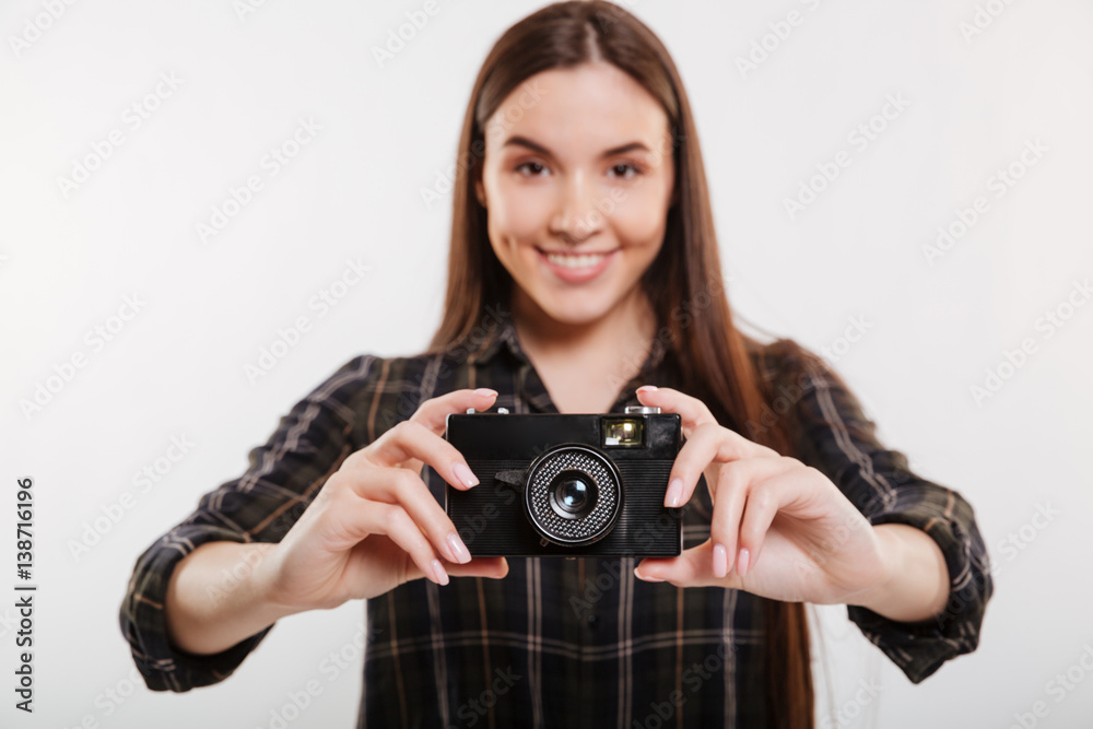 Smiling Woman in shirt holding retro camera Smiling Woman in shirt holding retro camera