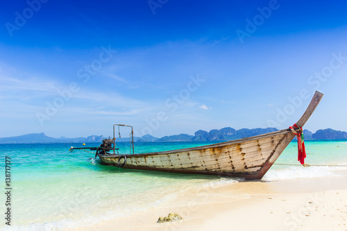 Thailand summer travel sea, Thai old wood boat at sea beach Krabi Phi Phi Island Phuket park on white sand blue sky emerald green ocean water.