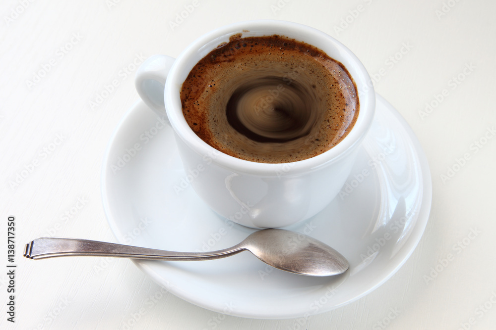 cup of coffee/ cup of black coffee and a teaspoon on a saucer cup of coffee/ cup of black coffee and a teaspoon on a saucer
