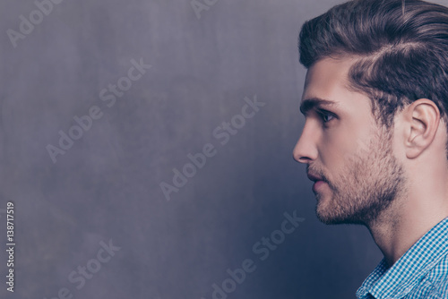 Side view portrait of young handsome confident guy