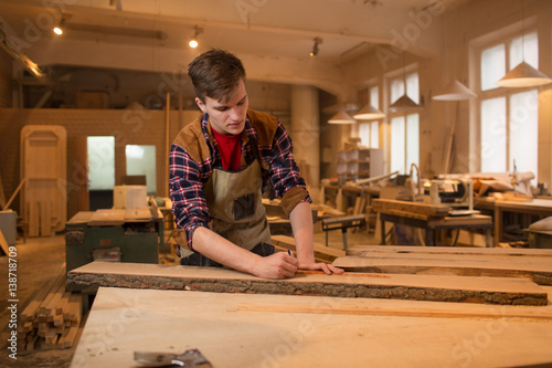 Carpenter is studying,works with the tools without protection photo