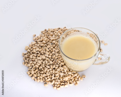 Soy milk cup and soy bean on white background view from above.