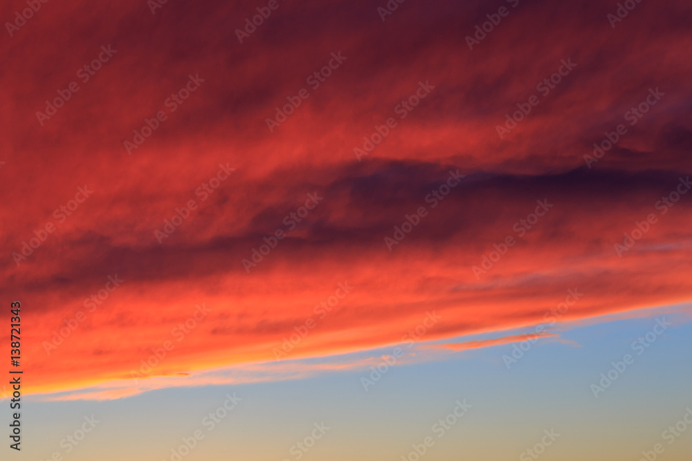 Beautiful sky background. Fiery orange dramatic sunset sky with cloud