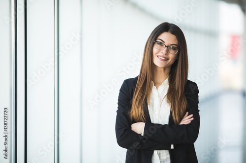 Smiling young Business woman crossed arms, standing against office Free Download Smiling young Business woman crossed arms, standing against office - GFXLoad