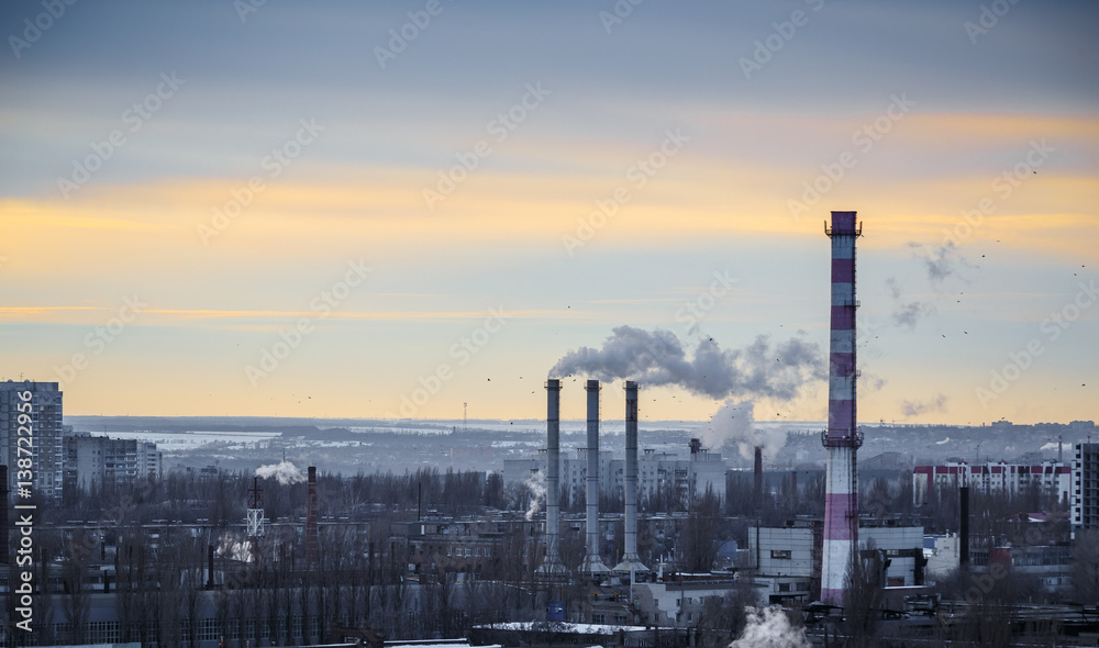 Industrial urban area landscape. Power station with pipes of which poured smoke.