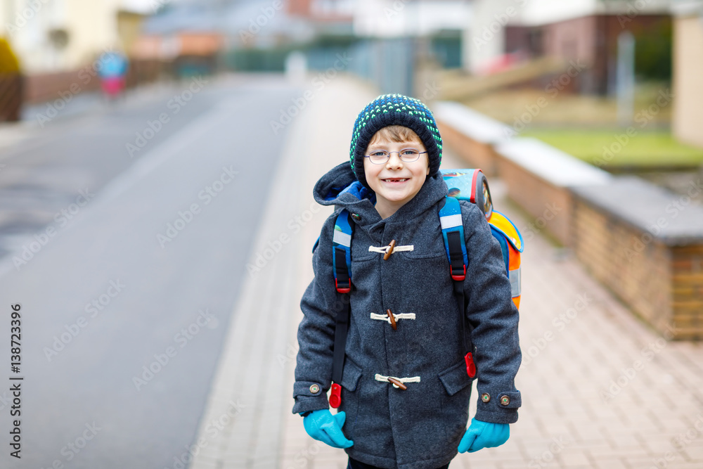 Little kid boy with eye glasses walking from the school Little kid boy with eye glasses walking from the school