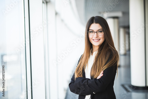 Free Download Businesswoman crossed hands portrait in office with panormic windows. - GFXLoad
