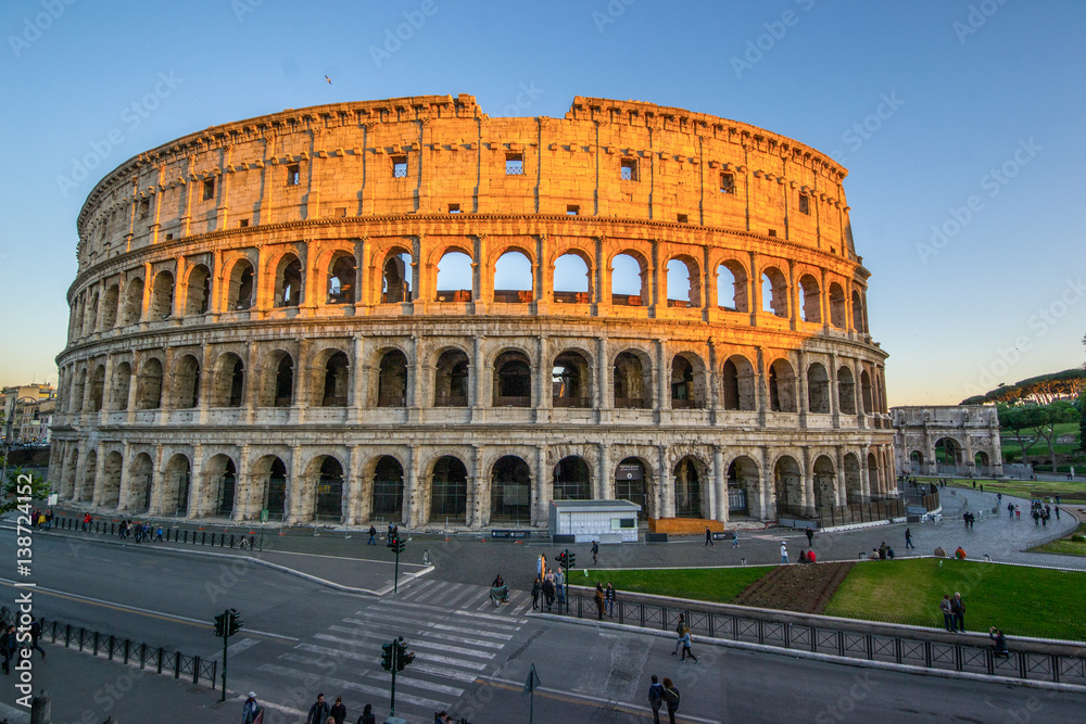 Low Angle view of the Colosseum Amphitheater in Rome against blue sky background.