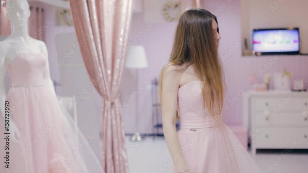 Pretty girl trying on prom gown and posing Pretty girl trying on prom gown and posing