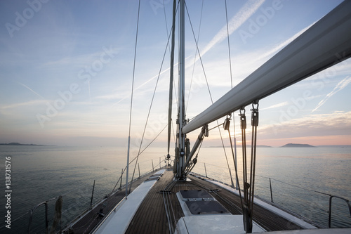 Fototapeta Naklejka Na Ścianę i Meble -  Luxury Sail Boat Sailing In Sea During Sunset