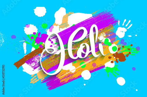 Happy holi on a background of hand prints.