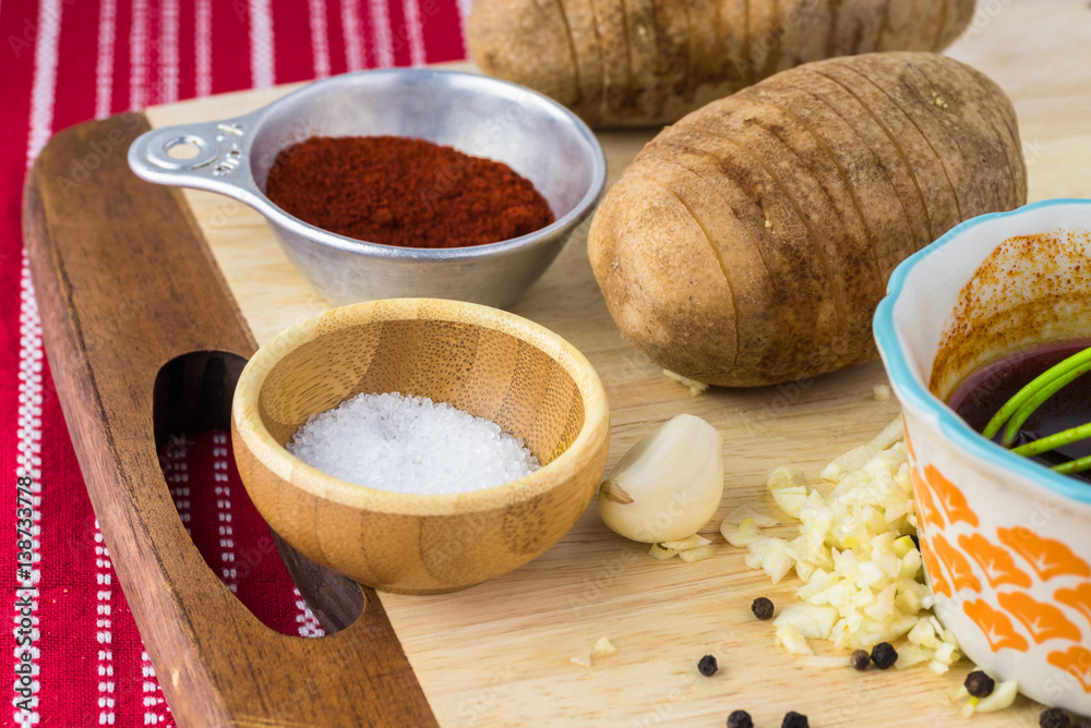 Ingredients for hasselback potatoes with smoked paprika and bacon. Ingredients for hasselback potatoes with smoked paprika and bacon.