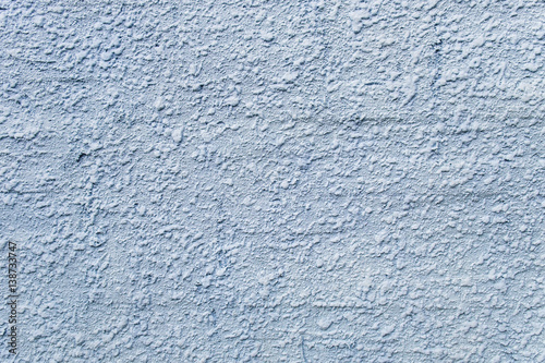 Embossed stucco grayish-bluish surface closeup. For background and texture.