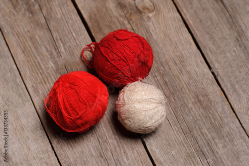 Different balls of yarn on rastic background photo